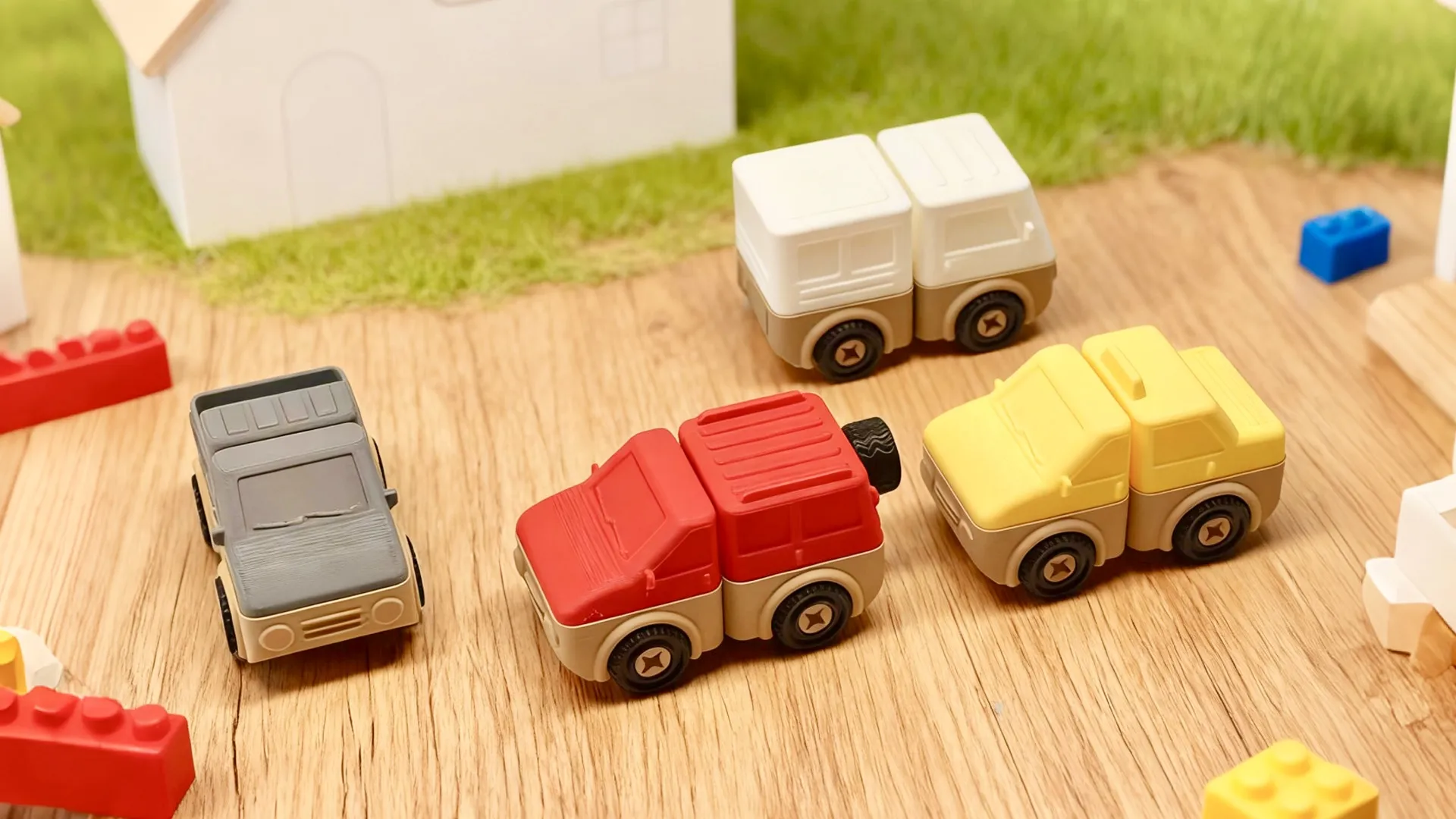 Buildable Block Cars — red, yellow, and white modular toy cars on a wooden table
